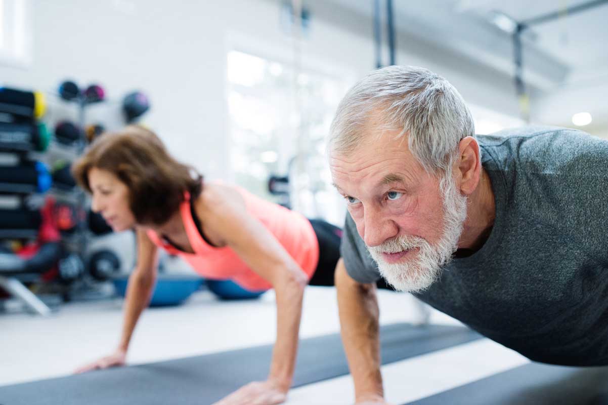 Image of man and woman doing pushups Image of man and woman doing pushups